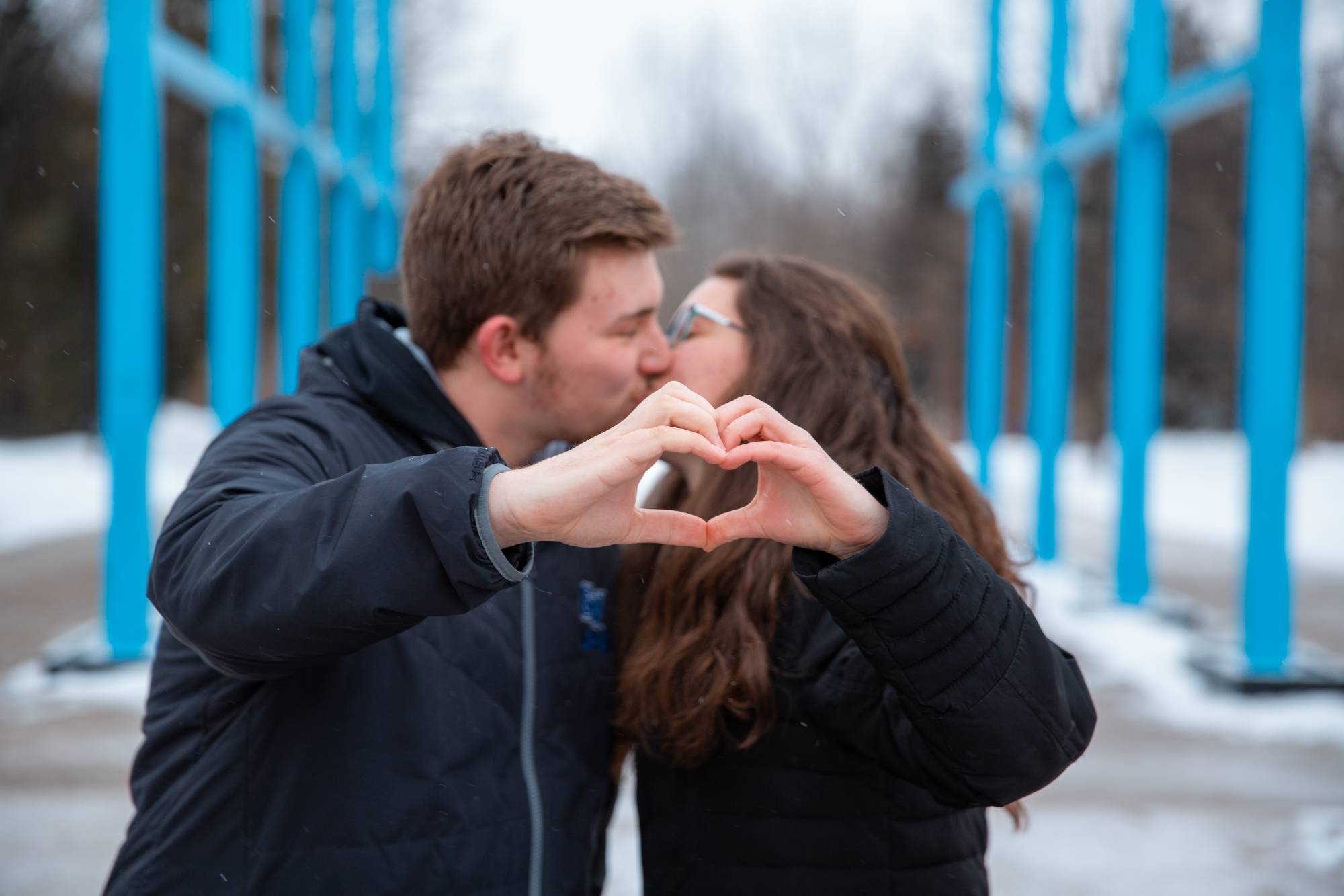 GVSU couple kissing in front of blue arch